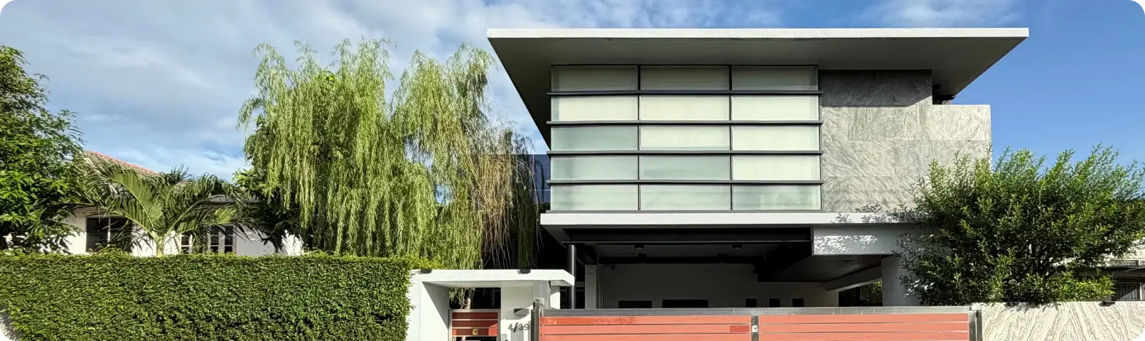 The Celestial Code office seen from the street, screened by trees